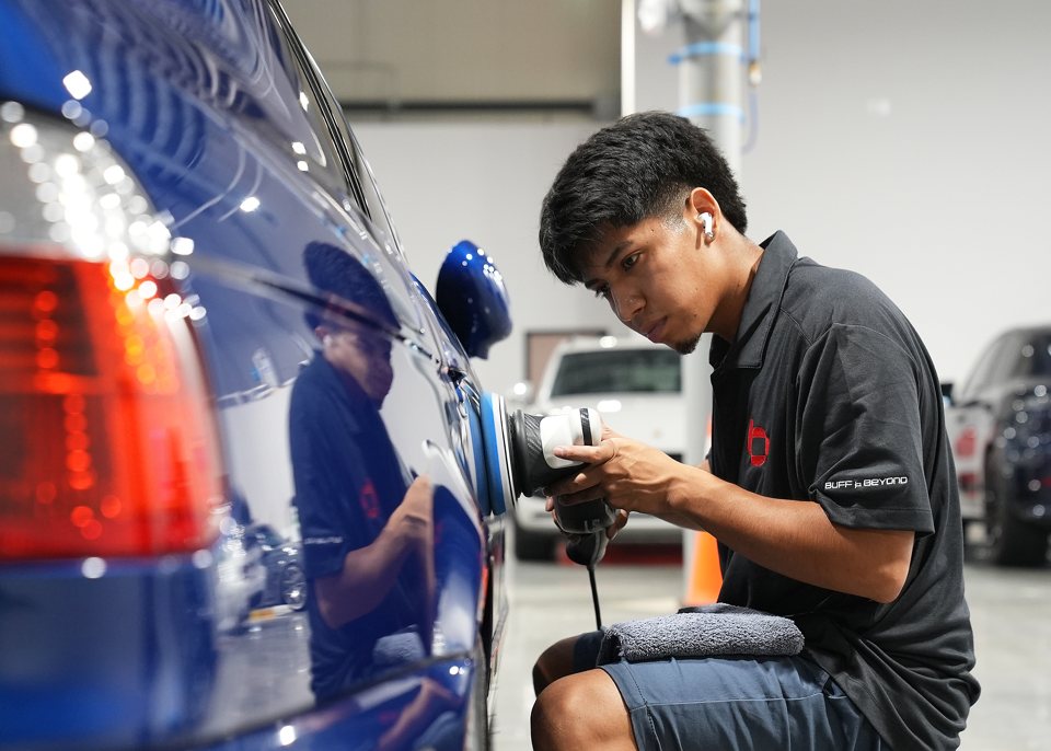 Polishing a blue BMW