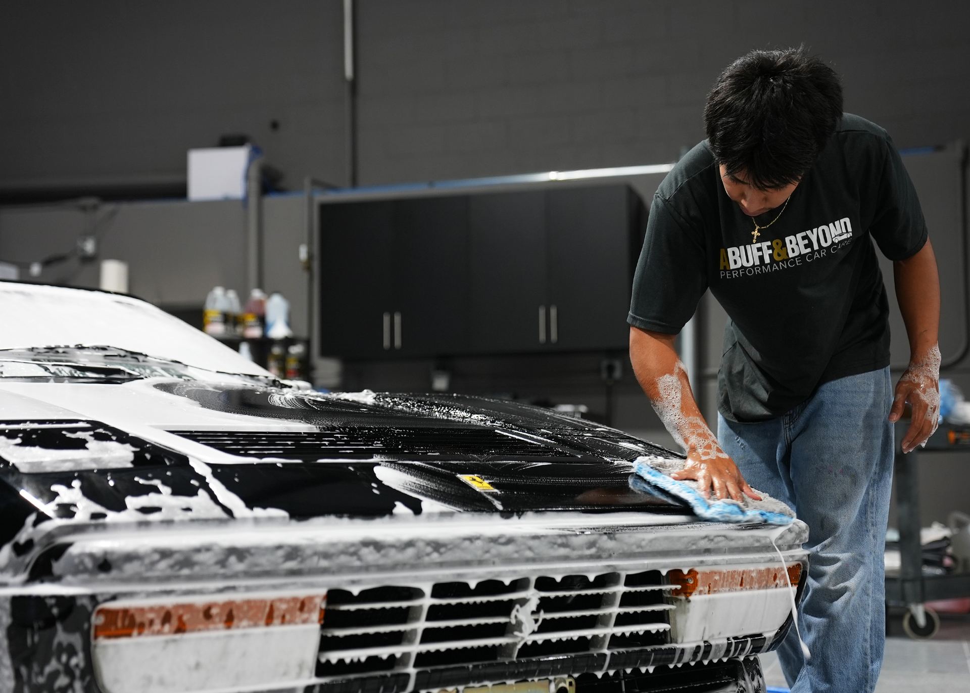 Hand wipe-down on a Ferrari 328 during detailing